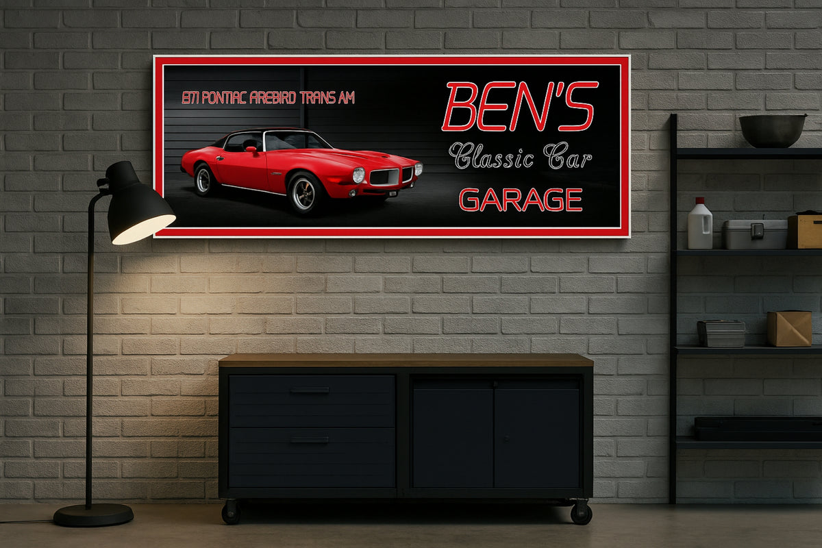 wall sign with a classic red muscle car and “Classic Car Garage” text mounted on a gray brick wall above a modern console table and floor lamp