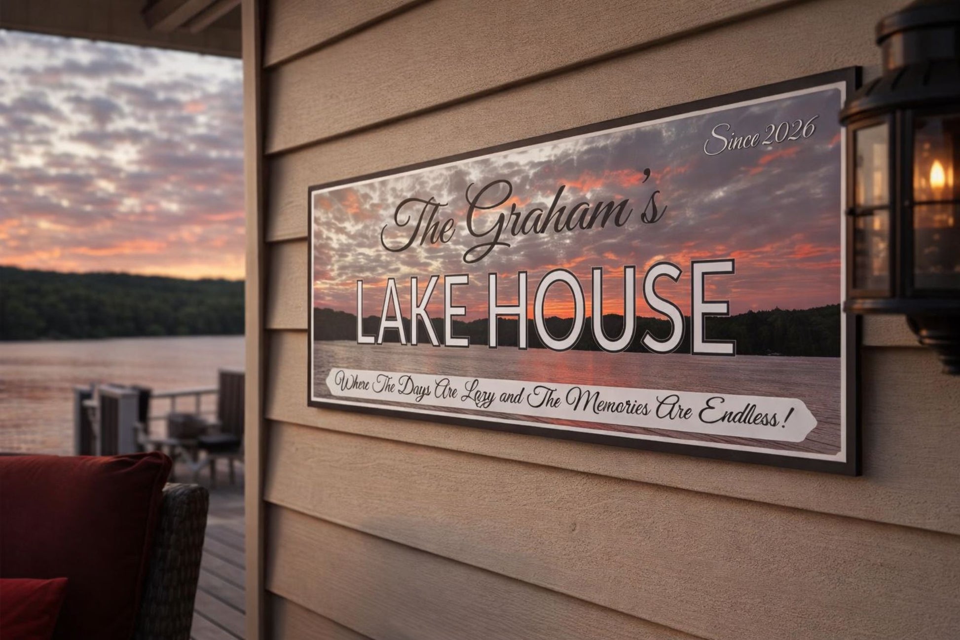 lake house wall sign mounted on exterior siding with sunset lake view in background