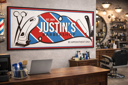 Custom barbershop sign with editable wording displayed on the wall of a classic barbershop interior above the counter, surrounded by grooming tools and barber chairs.