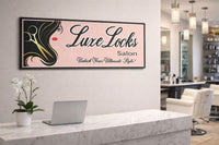 Modern hair salon interior with a personalized Luxe Locks Salon wall sign displayed behind a marble reception desk, showcasing a stylish beauty shop setting.