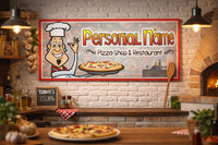 Personalized pizza restaurant wall sign featuring cartoon chef and custom shop name, displayed inside a cozy pizzeria with brick-style decor and warm lighting.