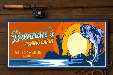 personalized fishing cabin sign on wooden surface with fishing rod and rope