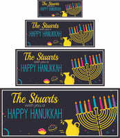 Personalized Happy Hanukkah sign featuring a menorah with colored candles, a milk pitcher, and donuts. All lines of text are editable for a custom holiday message.