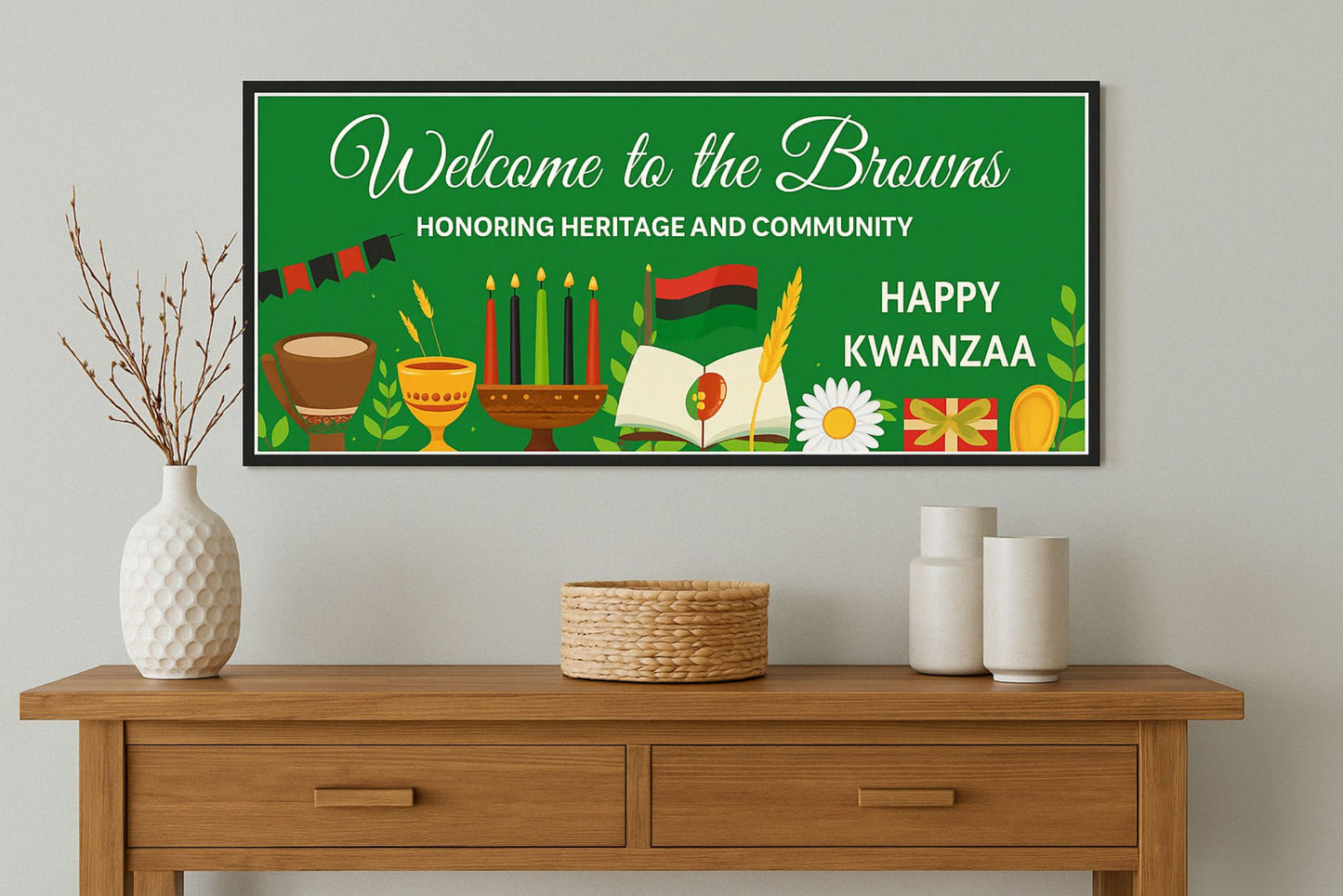 Kwanzaa wall sign displayed above a wooden console table with vases and basket in a modern home setting