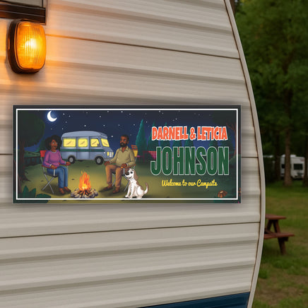 RV campsite sign displayed on the exterior of a camper with the lights on at night