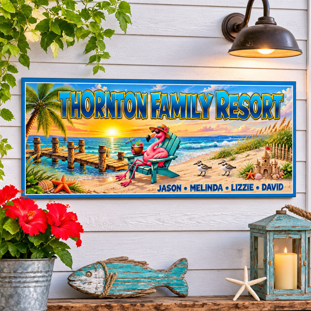Personalized flamingo beach resort sign mounted on a white coastal wall with tropical greenery, red flowers, and beach-themed decorations.