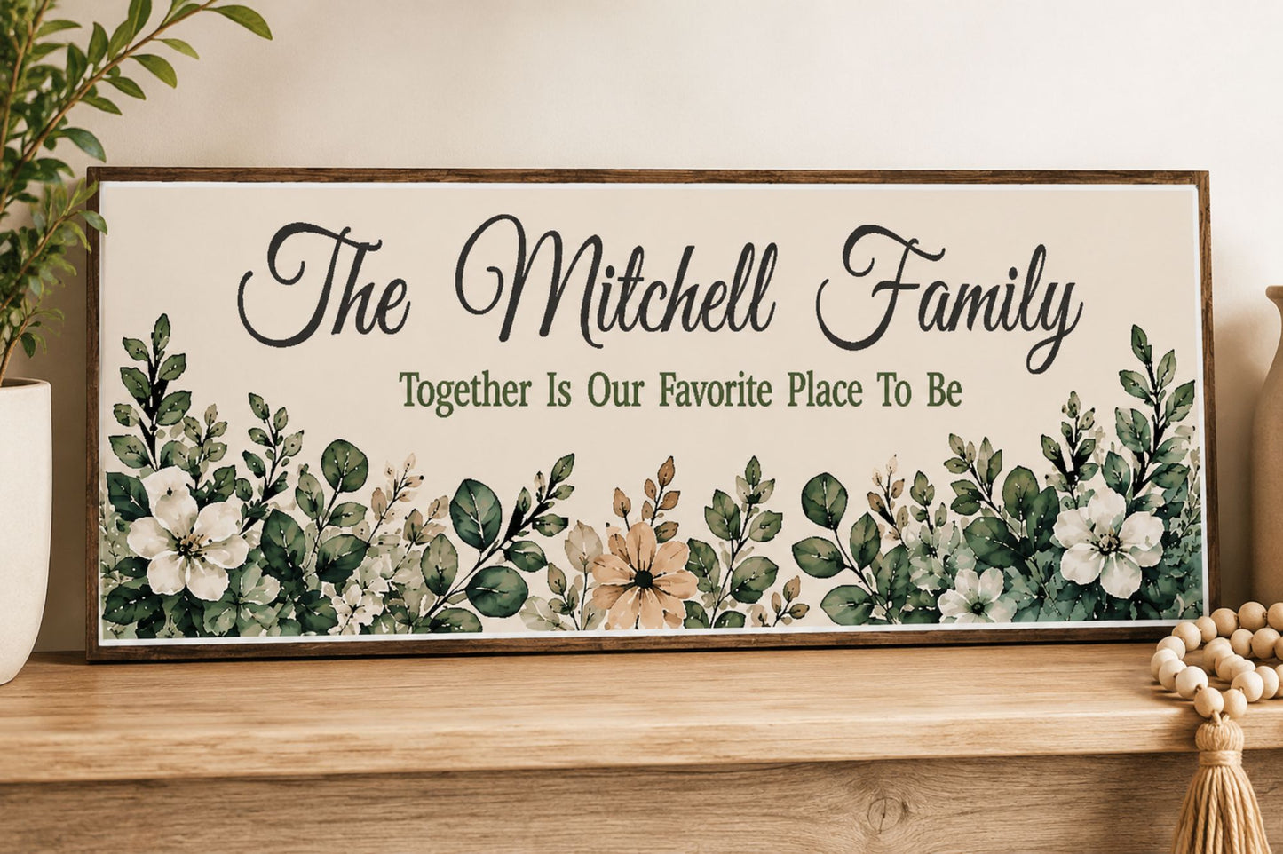 Close-up lifestyle image of personalized botanical family sign displayed on a wooden shelf in neutral home decor setting