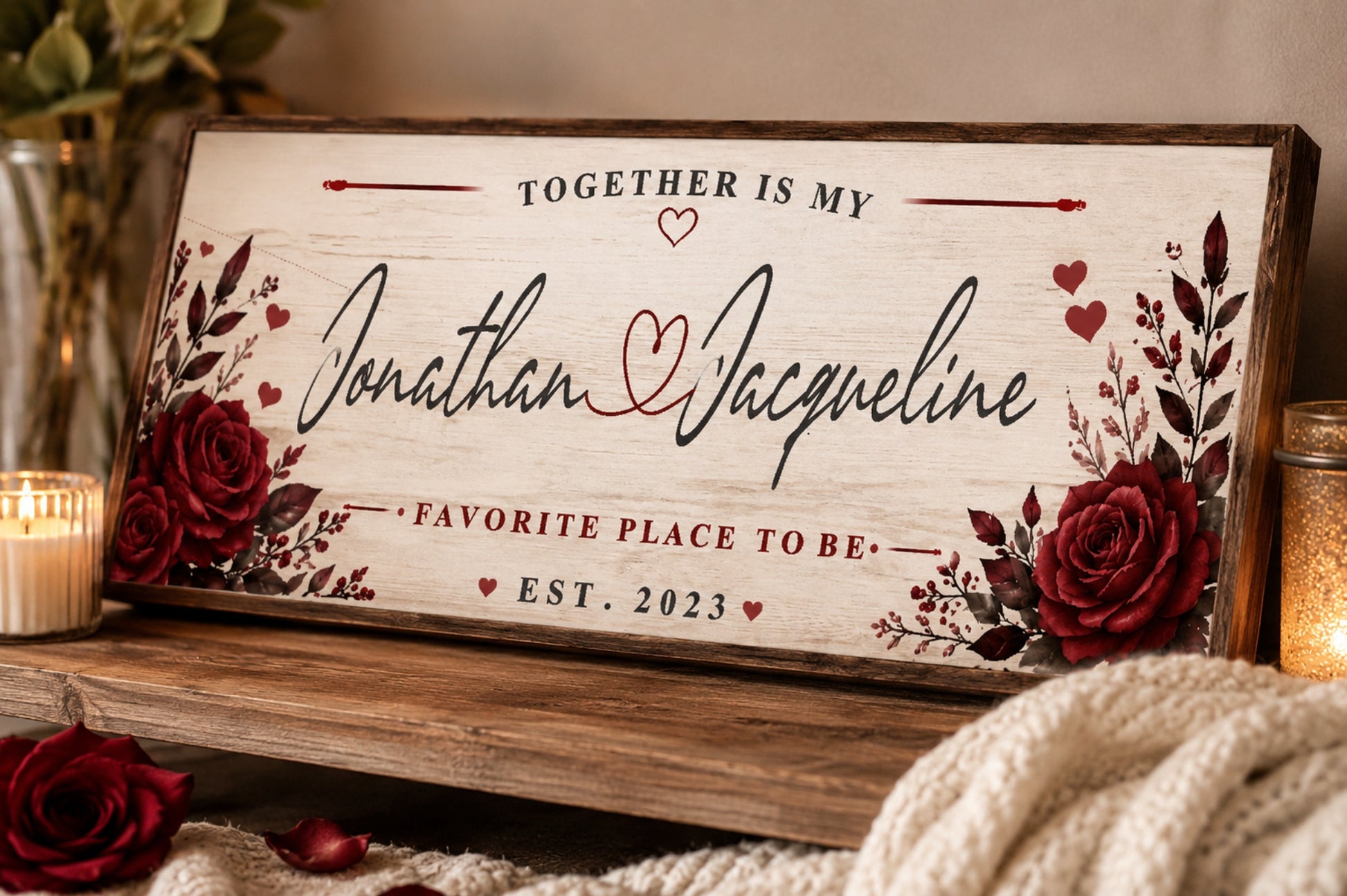 Close-up of personalized romantic couple sign with floral accents and customizable names displayed on a rustic shelf