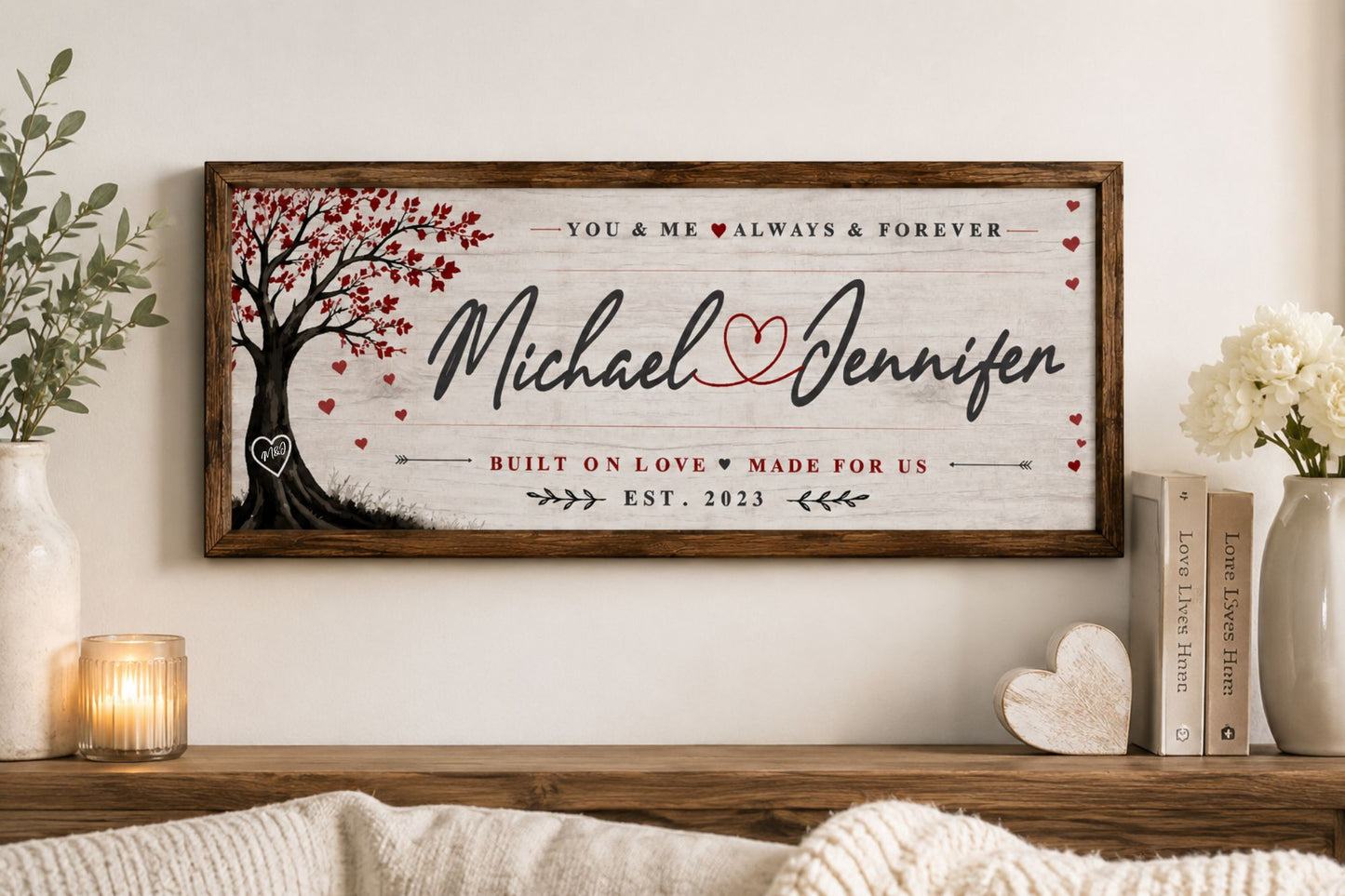 Personalized love sign mounted on wall with romantic couple names and heart artwork