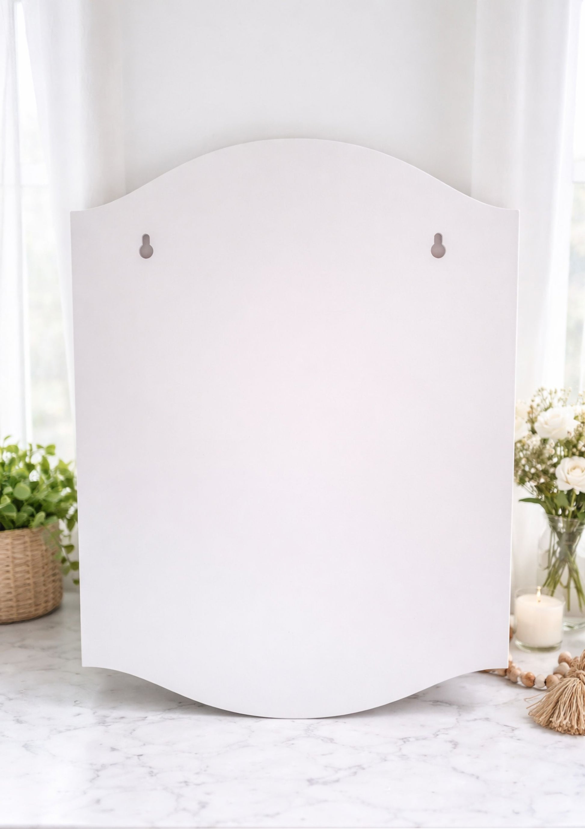 Close-up of the back of the sign showing keyhole slots for secure, ready-to-hang mounting on walls or fences