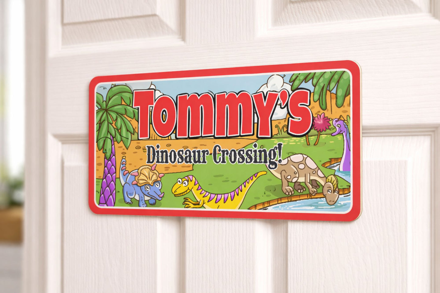 Dinosaur themed custom kids name sign mounted on bedroom door