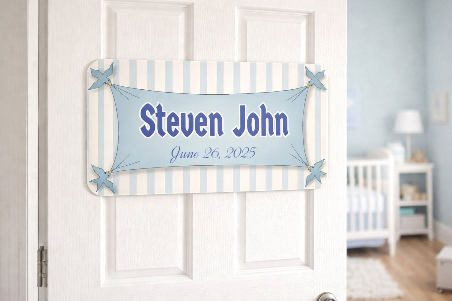 Nursery door with personalized birth announcement sign in soft pastel colors