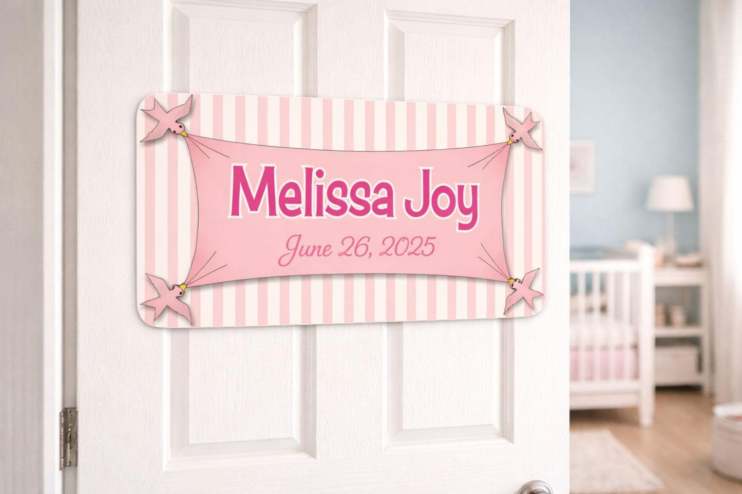Nursery door with personalized birth announcement sign in soft pastel colors