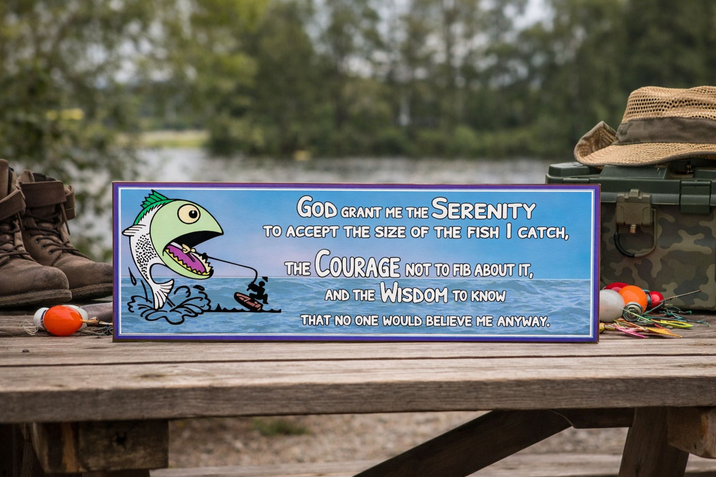 funny fishing prayer sign with cartoon fish and ocean background displayed on a bench