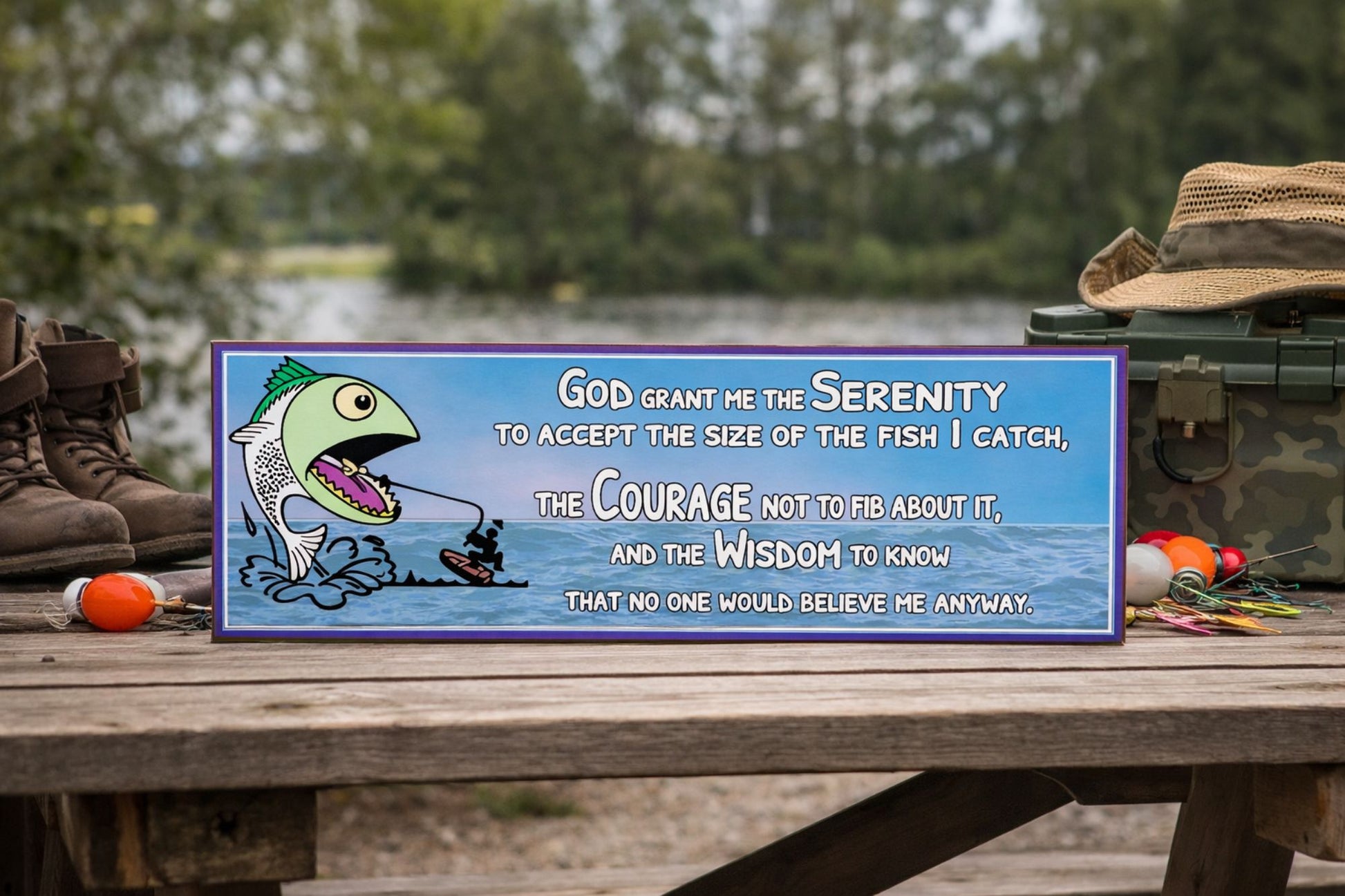 funny fishing prayer sign with cartoon fish and ocean background displayed on a bench
