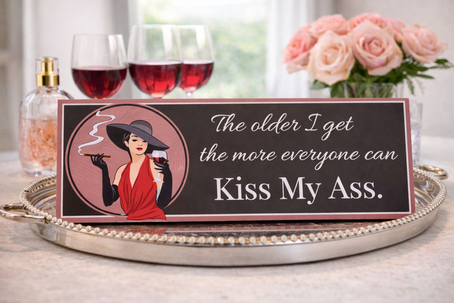 wine humor sign styled on vanity dresser with perfume and flowers