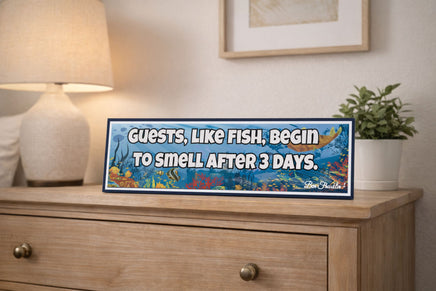 humorous guest room quote sign displayed on dresser in bedroom setting