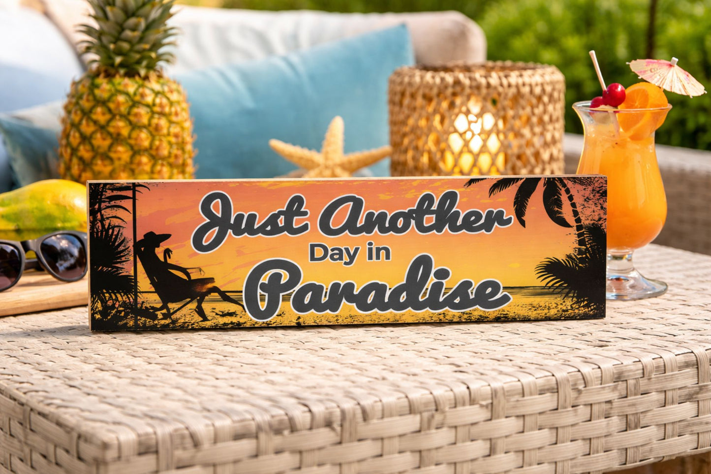 tropical paradise sign on wicker table with cocktail pineapple and beach decor