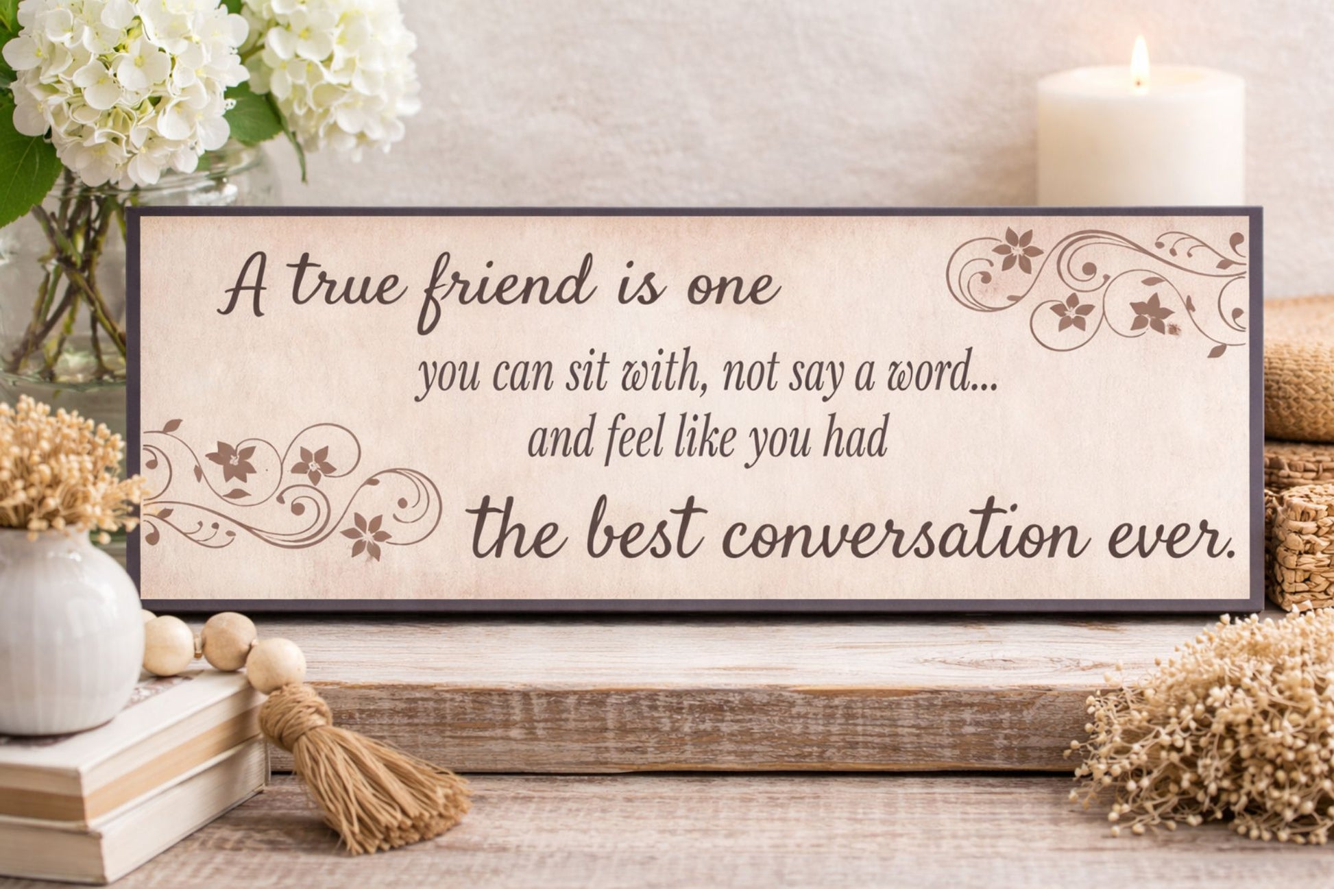 lifestyle friendship quote decor displayed on tabletop with flowers candle and rustic accents