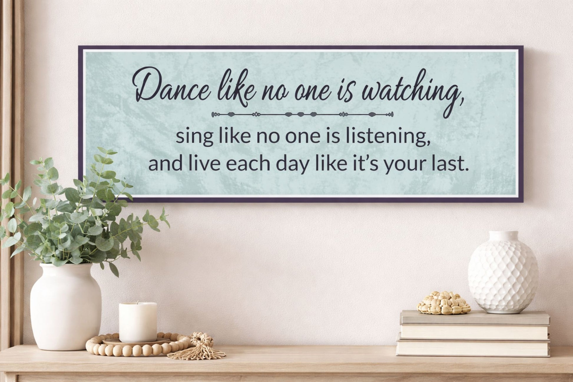 Inspirational quote wall sign styled above console table in calming decor