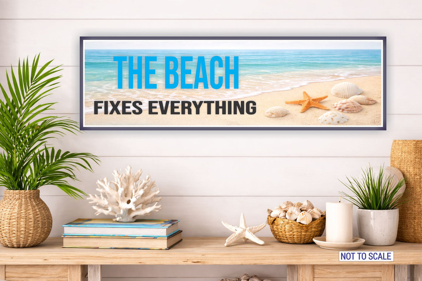 beach house wall decor sign displayed on shelf with coral seashell decor and coastal plants