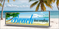 Coastal beach wall sign reading The Beach Fixes Everything displayed in seaside home décor