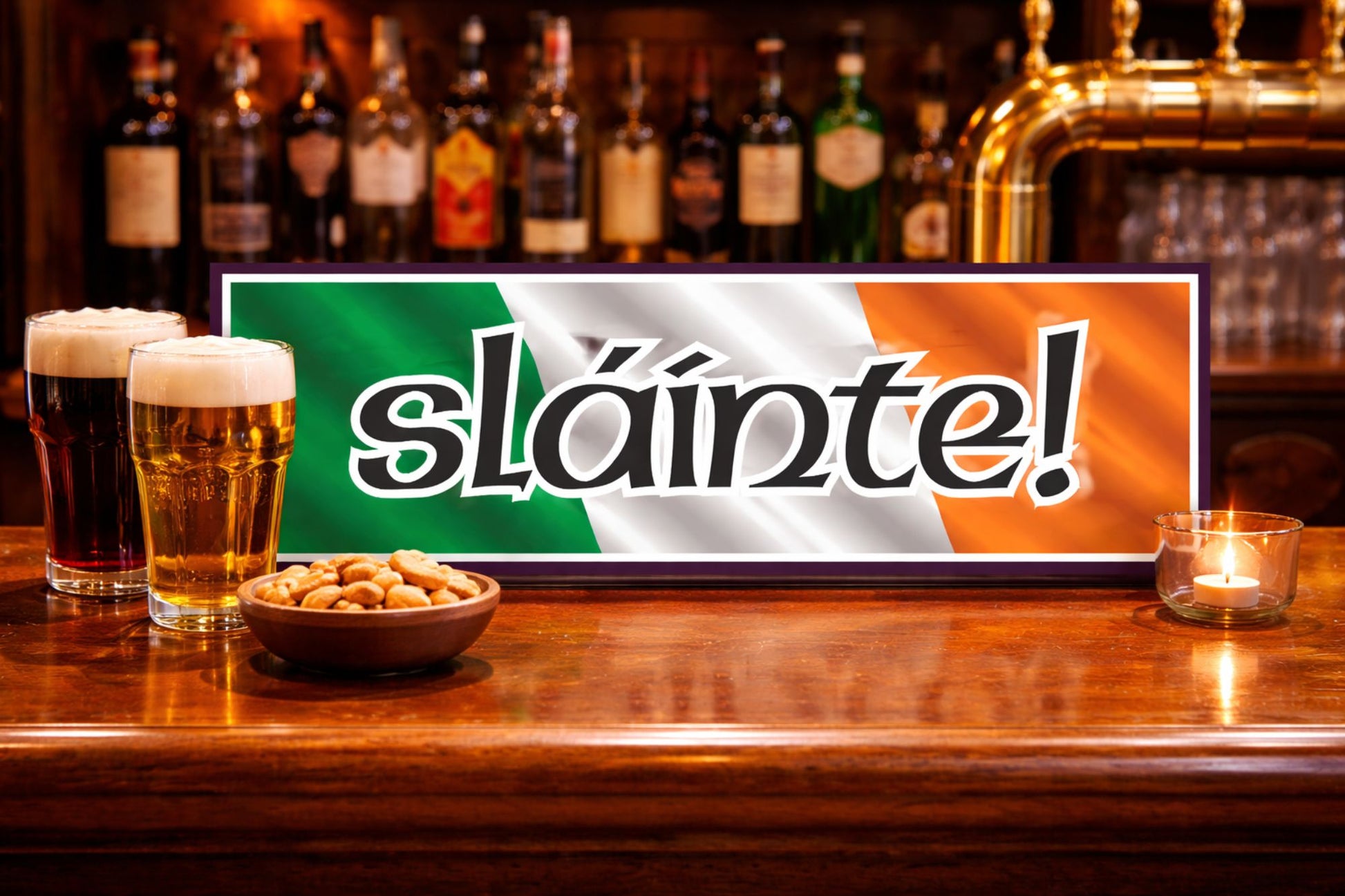 irish slainte bar sign resting on wooden pub bar top with pints of beer and warm irish pub background