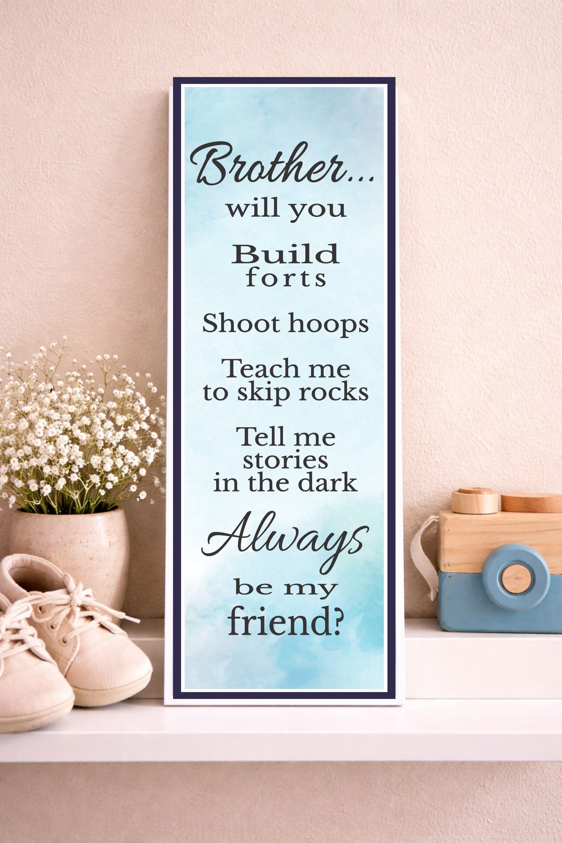 brother sign styled on shelf with baby shoes and soft neutral decor