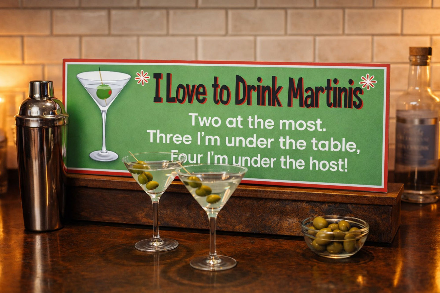 Martini quote sign sitting on a bar top with martini glasses and cocktail accessories in a home bar setting
