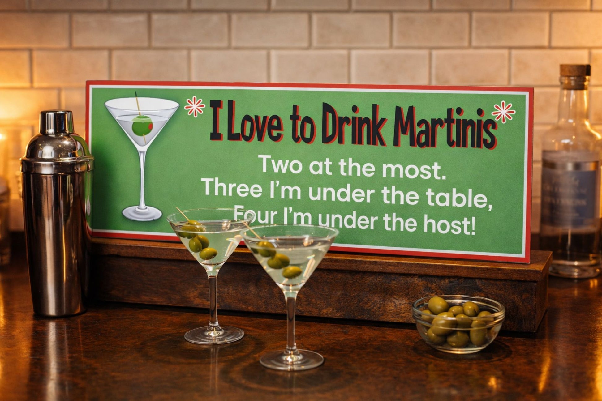 Martini quote sign sitting on a bar top with martini glasses and cocktail accessories in a home bar setting