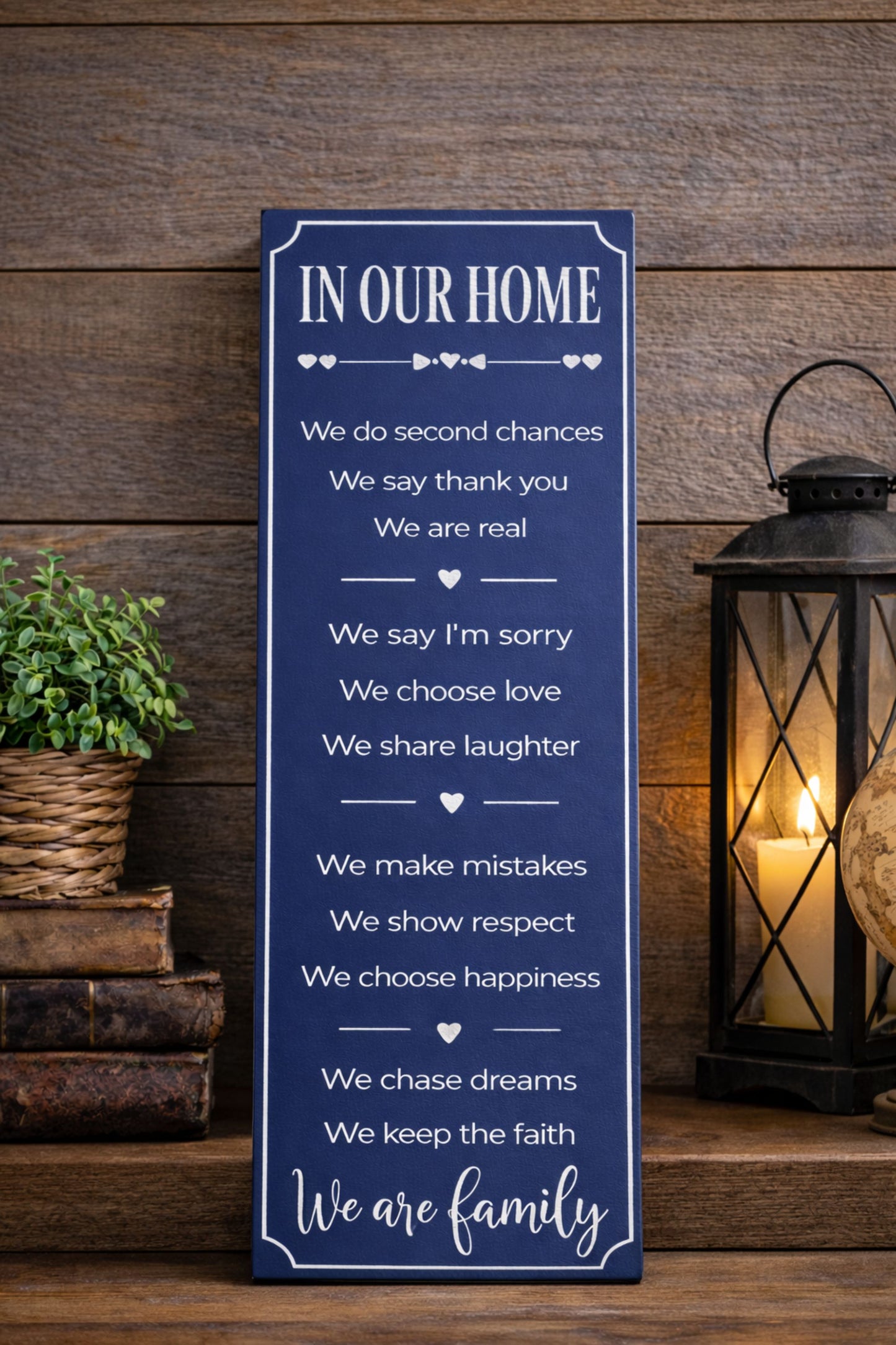 vertical family rules sign displayed on entryway table with lantern and books 