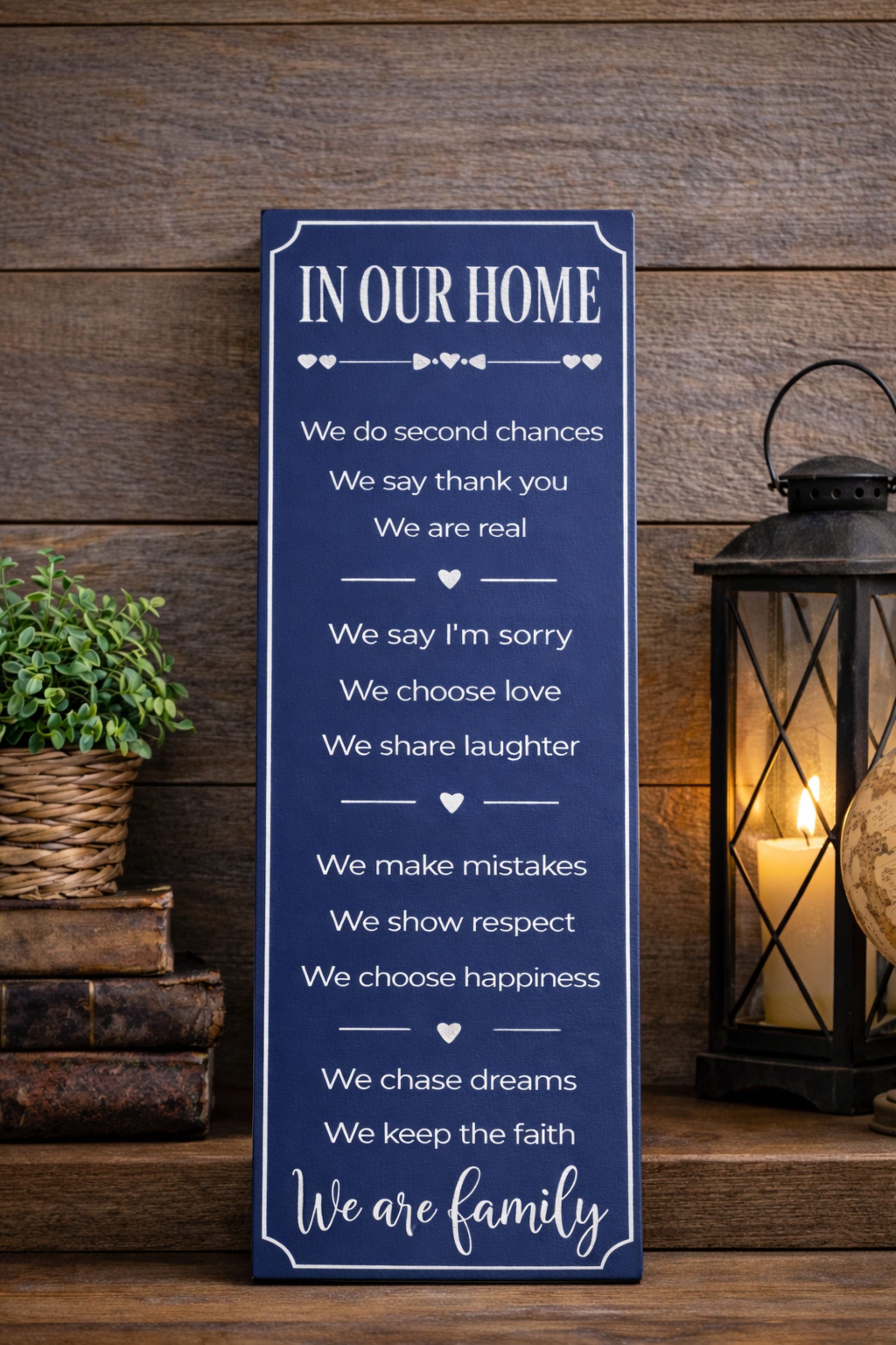 vertical family rules sign displayed on entryway table with lantern and books 
