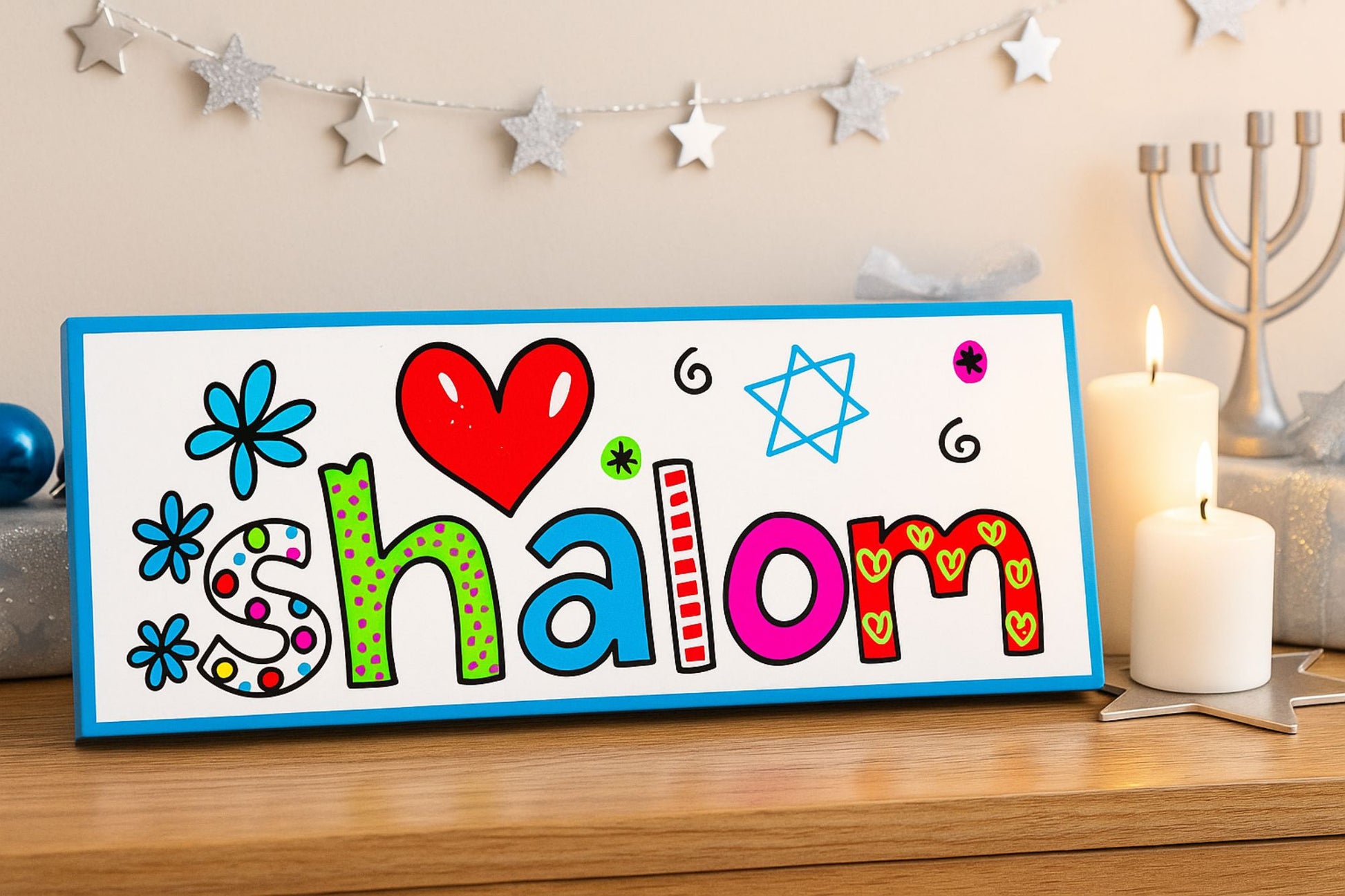 Shalom wall sign with colorful lettering and Star of David displayed on wooden shelf with candles and menorah in festive Jewish home setting