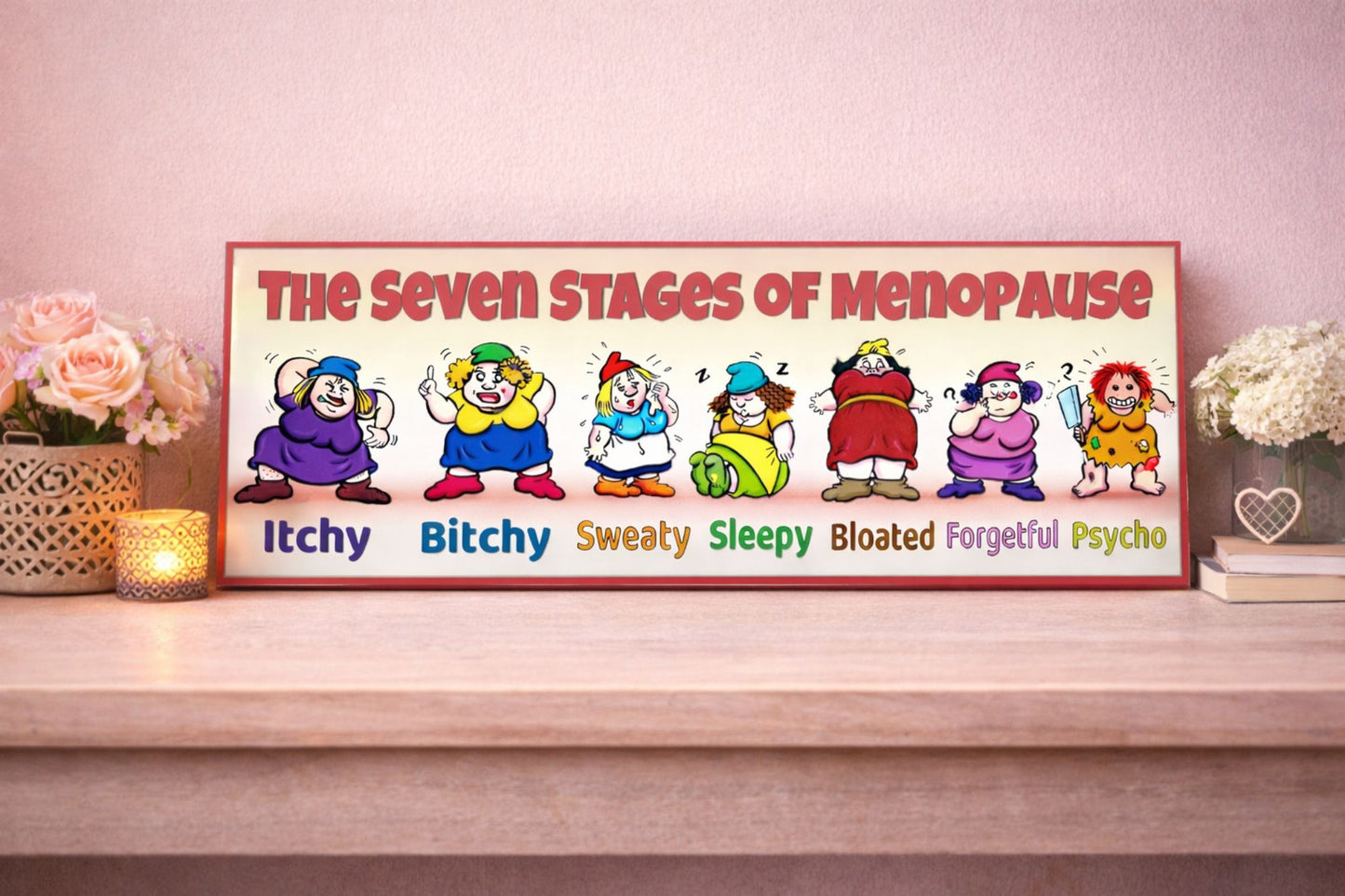seven stages of menopause sign funny women gift displayed on shelf with pink wall flowers and candle feminine decor