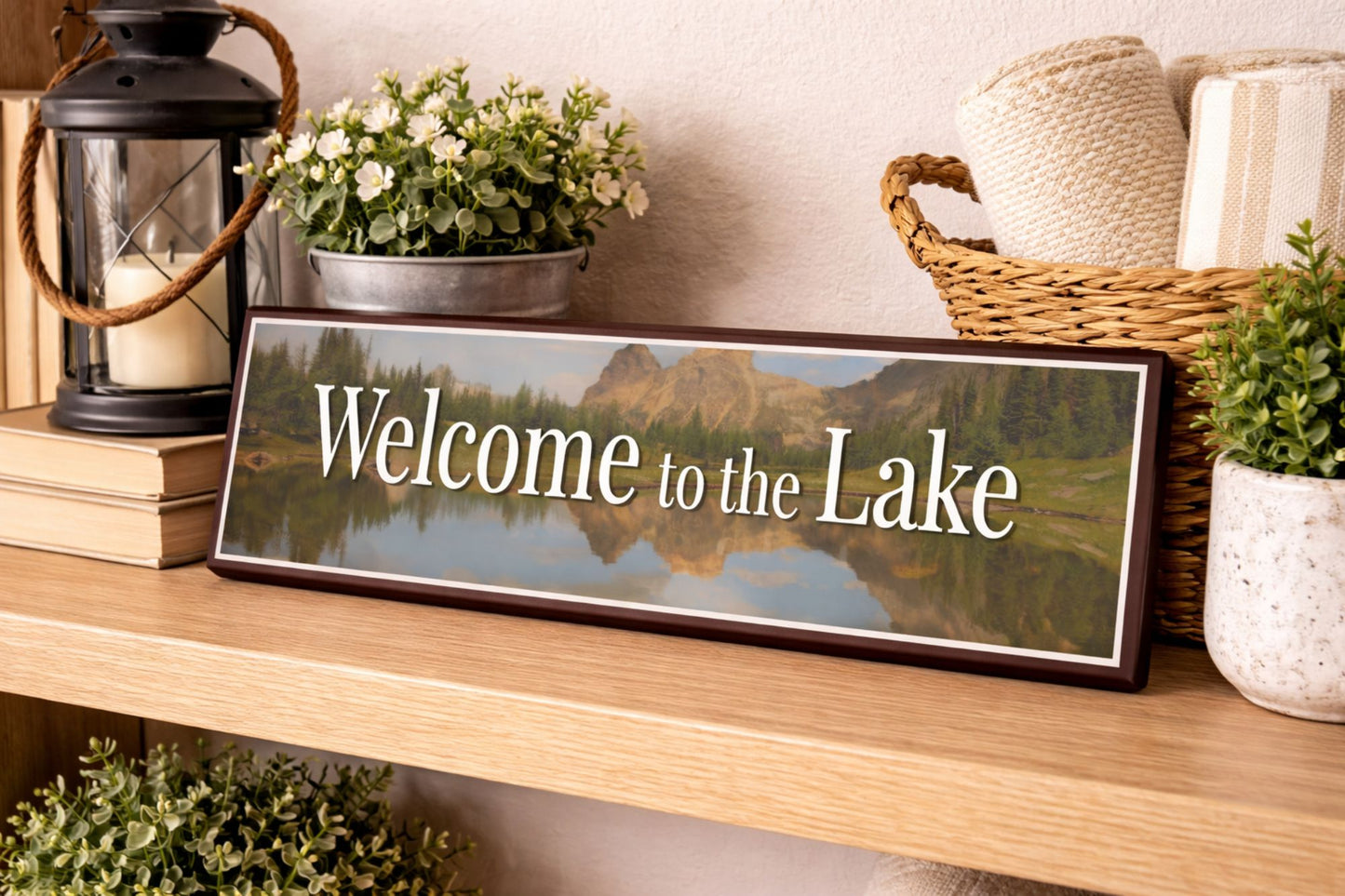 lake house sign welcome to the lake displayed on wooden shelf with rustic decor