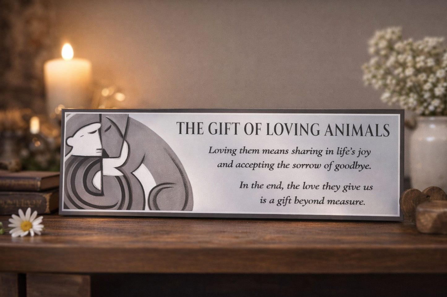 pet memorial sign displayed on wooden shelf with candle and flowers in soft lighting