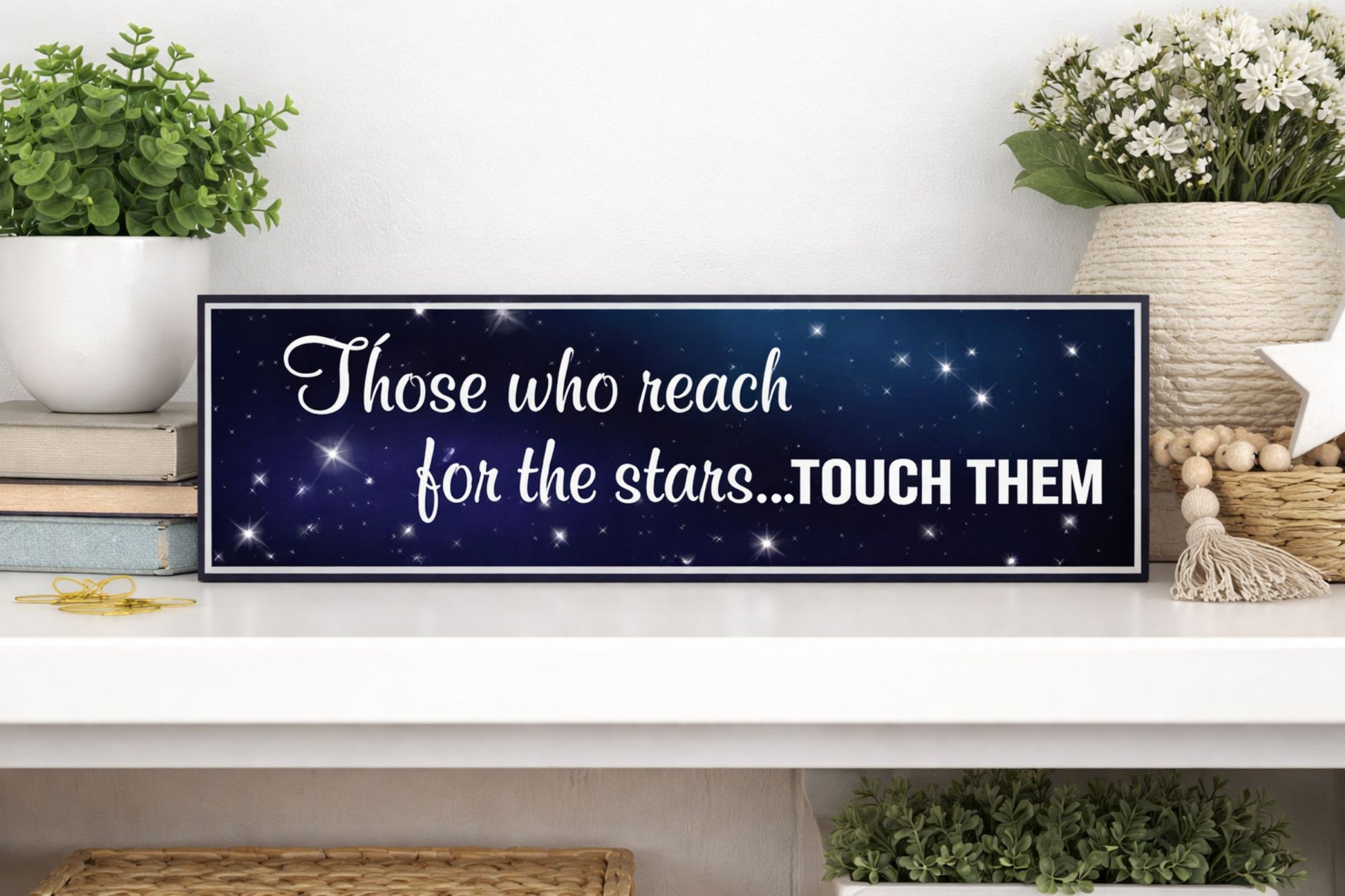 lifestyle image of motivational stars sign displayed on shelf with books plants and neutral home decor