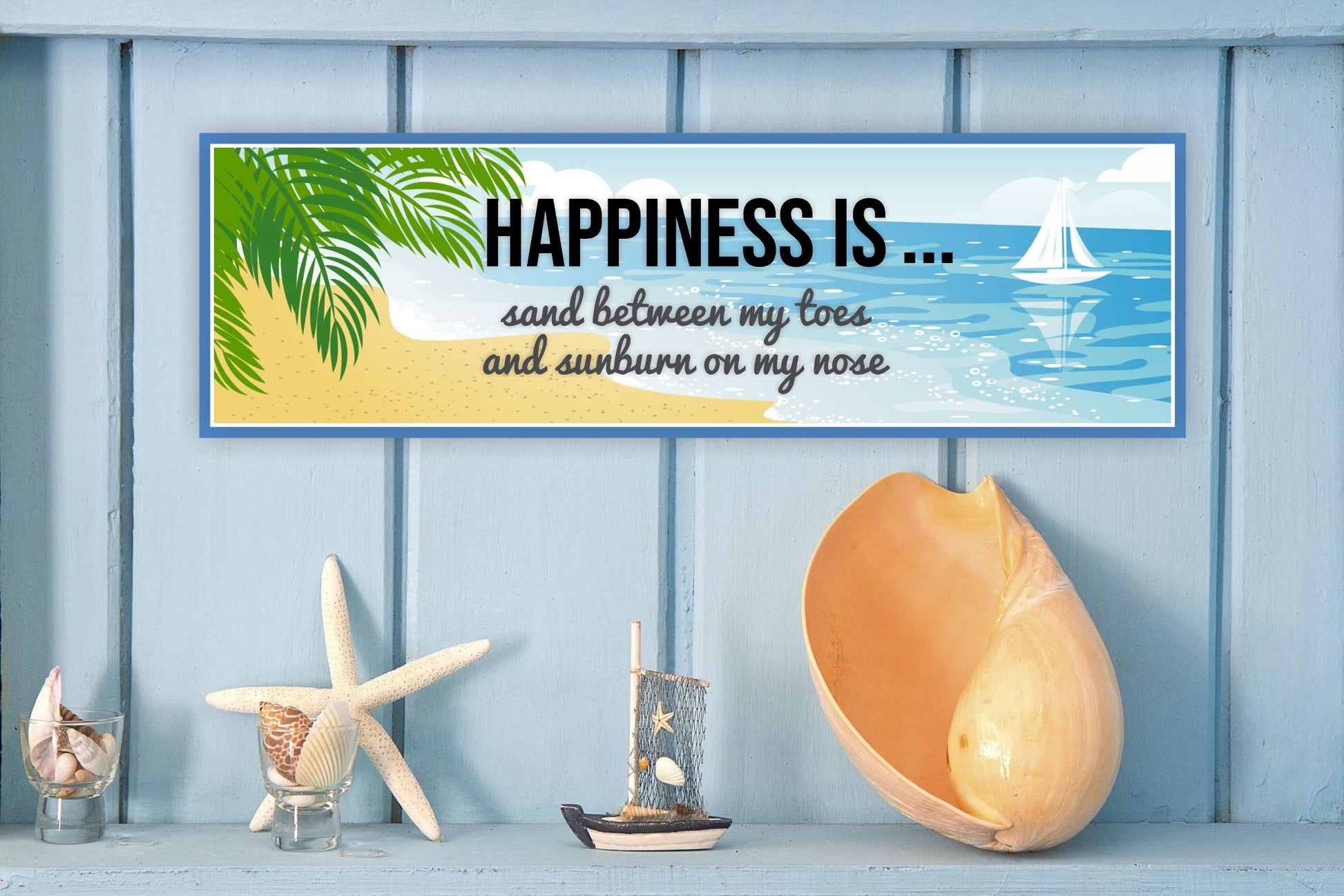 coastal beach wall decor sign displayed on blue wall with seashell accents