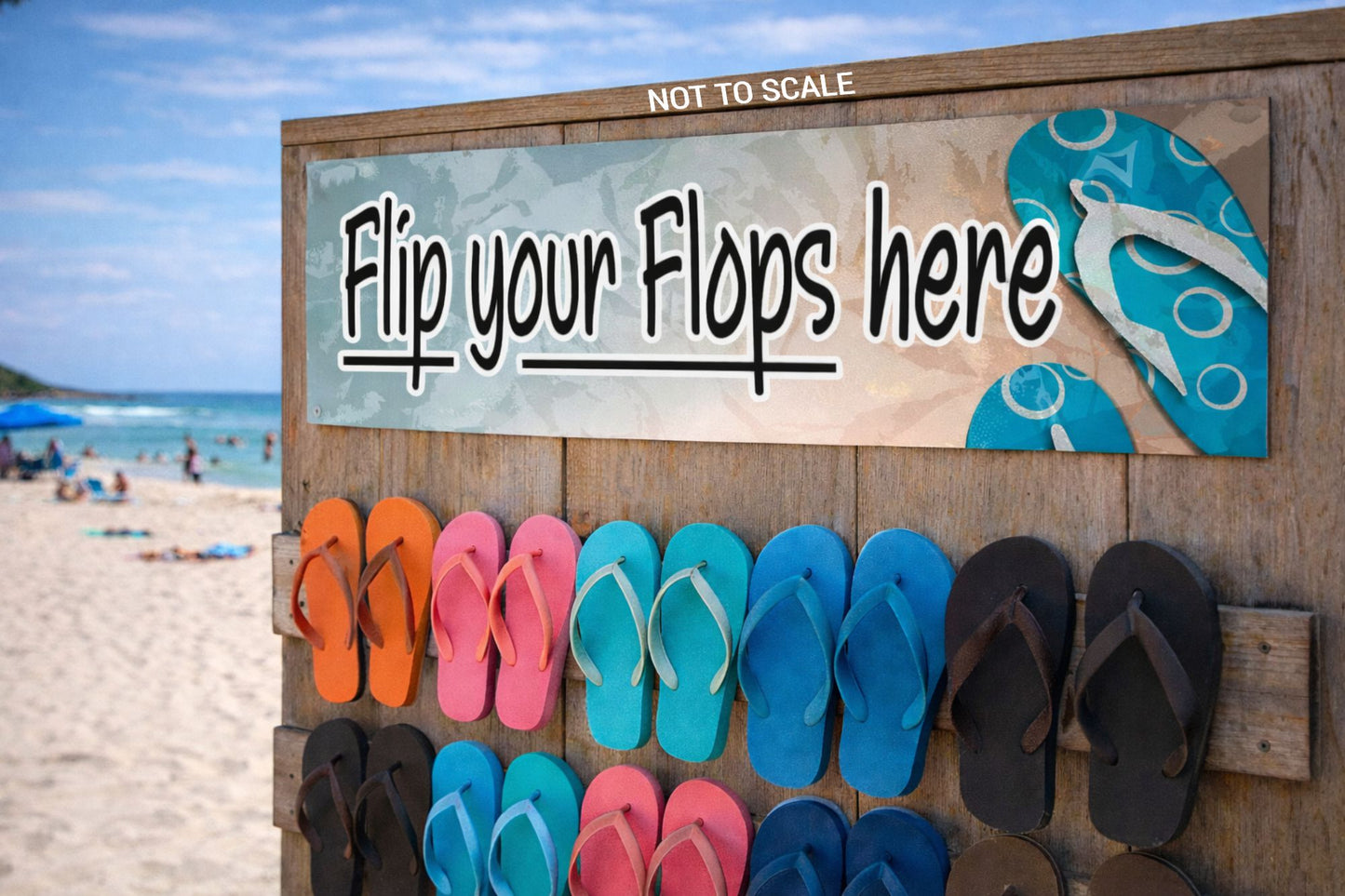 Flip Your Flops Here sign mounted on a wooden wall above a flip-flop rack at the beach