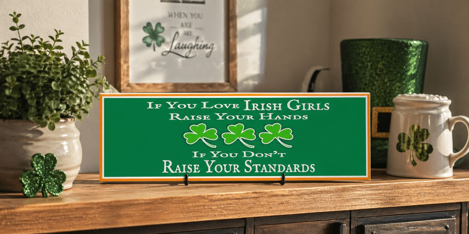 lifestyle image of funny Irish girls sign displayed on wooden shelf with St Patrick’s Day decor