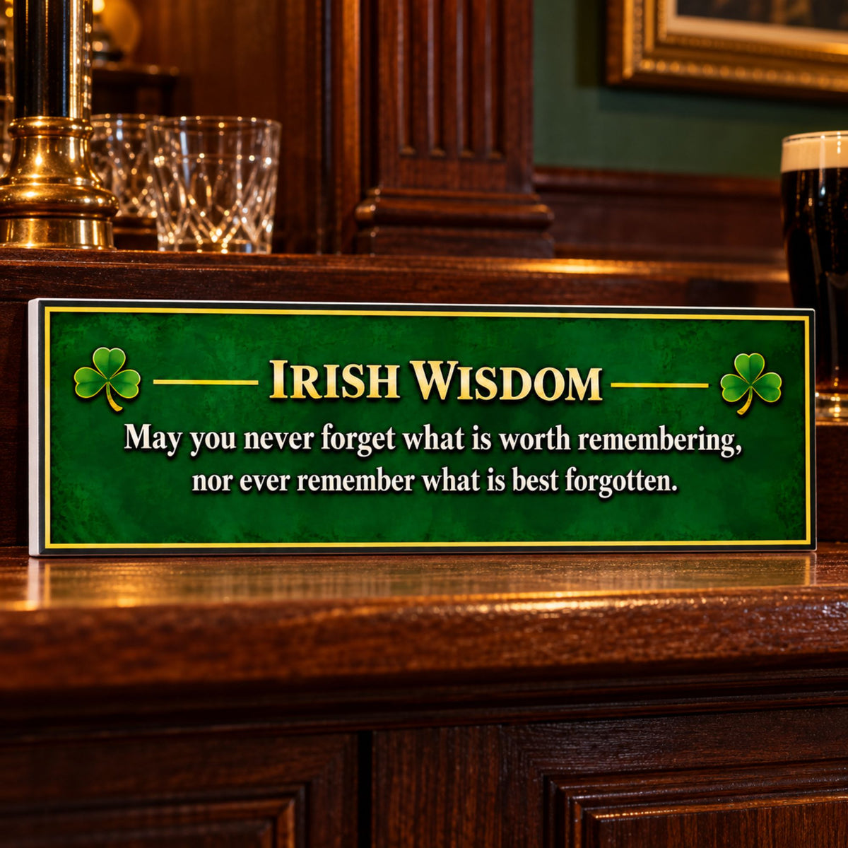 Emerald green Irish Wisdom sign displayed on a polished wooden bar in a cozy Irish pub, with a subtle white PVC edge visible on the left.