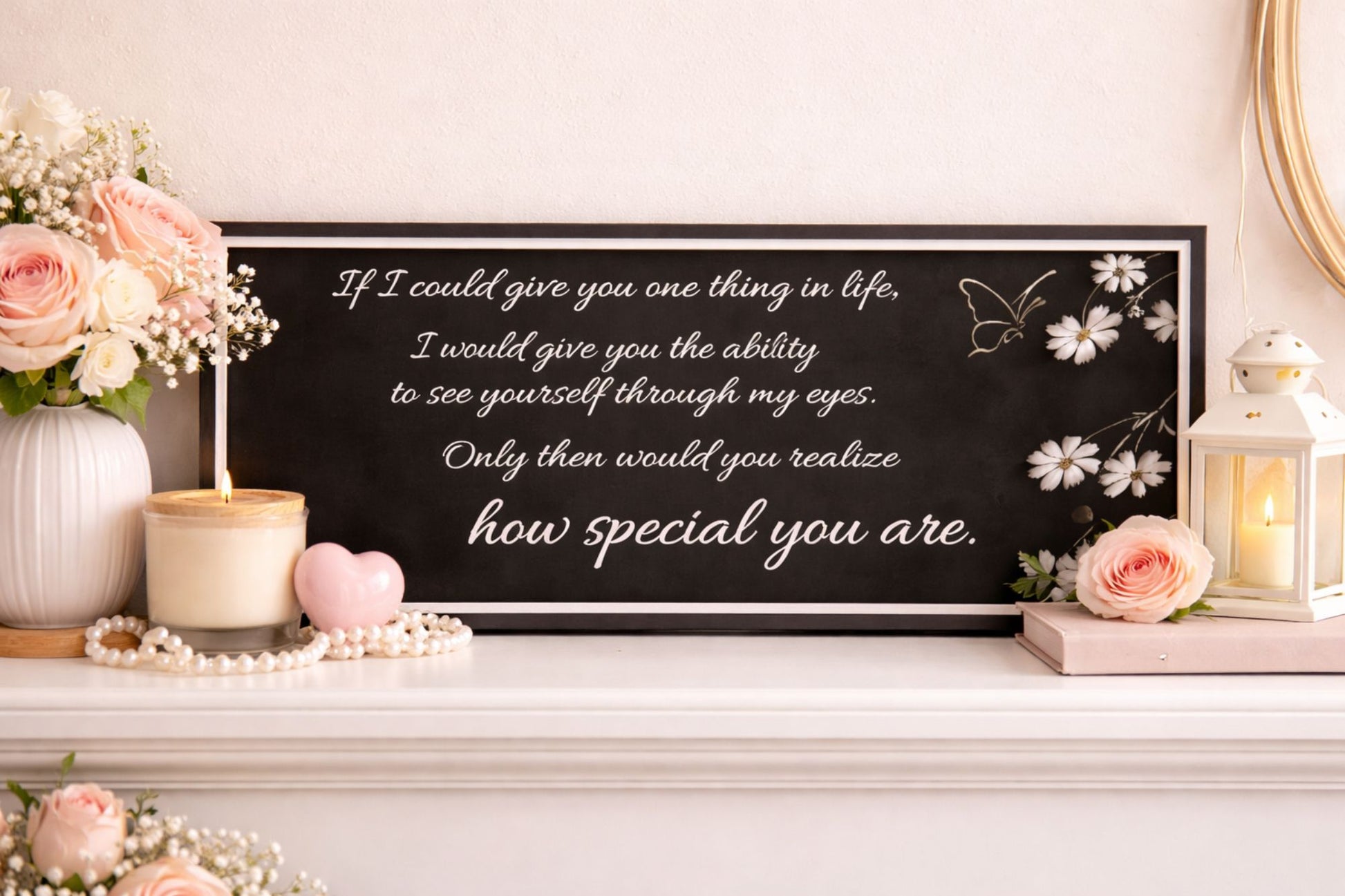 love quote sign displayed on shelf with candle flowers and soft romantic decor
