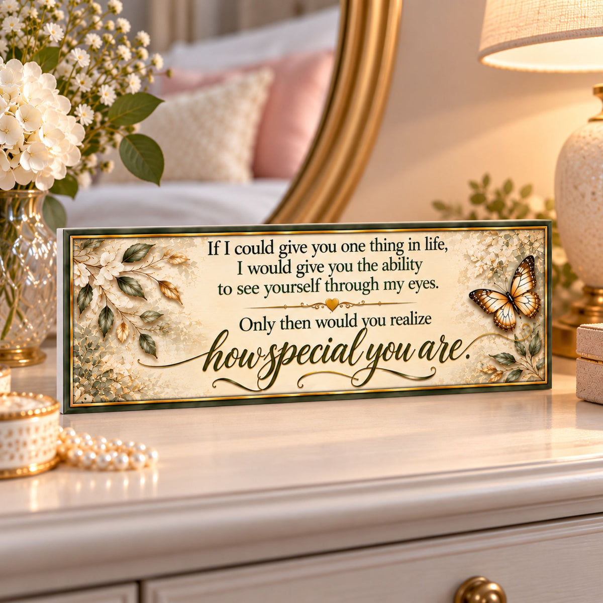 Inspirational message sign displayed on a bedroom dresser with elegant neutral decor and butterfly accents.