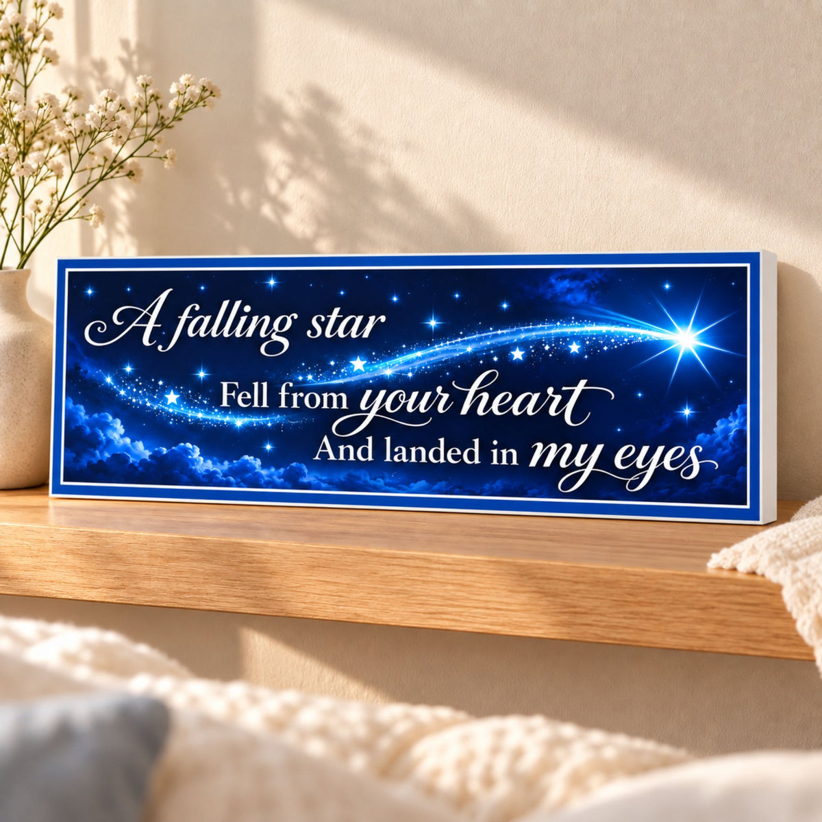 Midnight blue falling star quote sign displayed on an oak shelf with neutral decor, showing white lettering and a subtle white PVC edge.