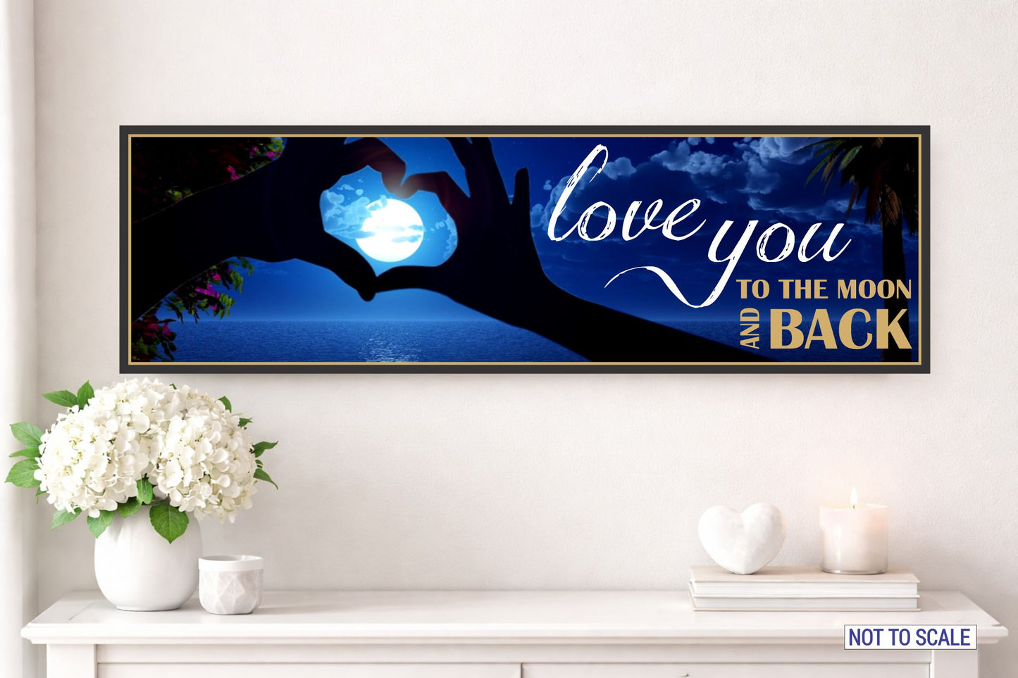 love you to the moon and back romantic wall sign displayed above a white console table with flowers and candles