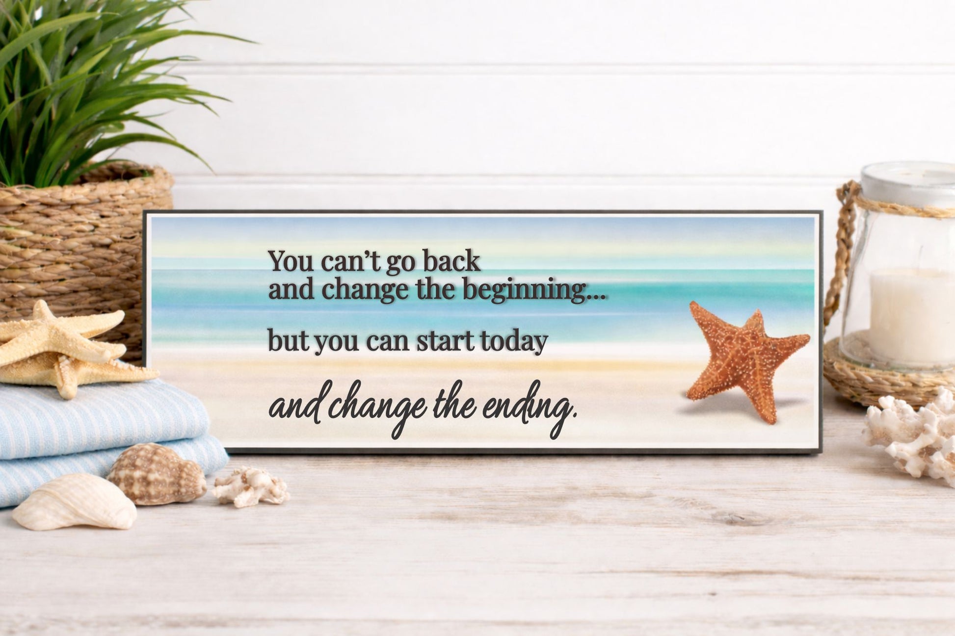 Lifestyle: beach themed motivational sign displayed on shelf with towels seashells and coastal decor