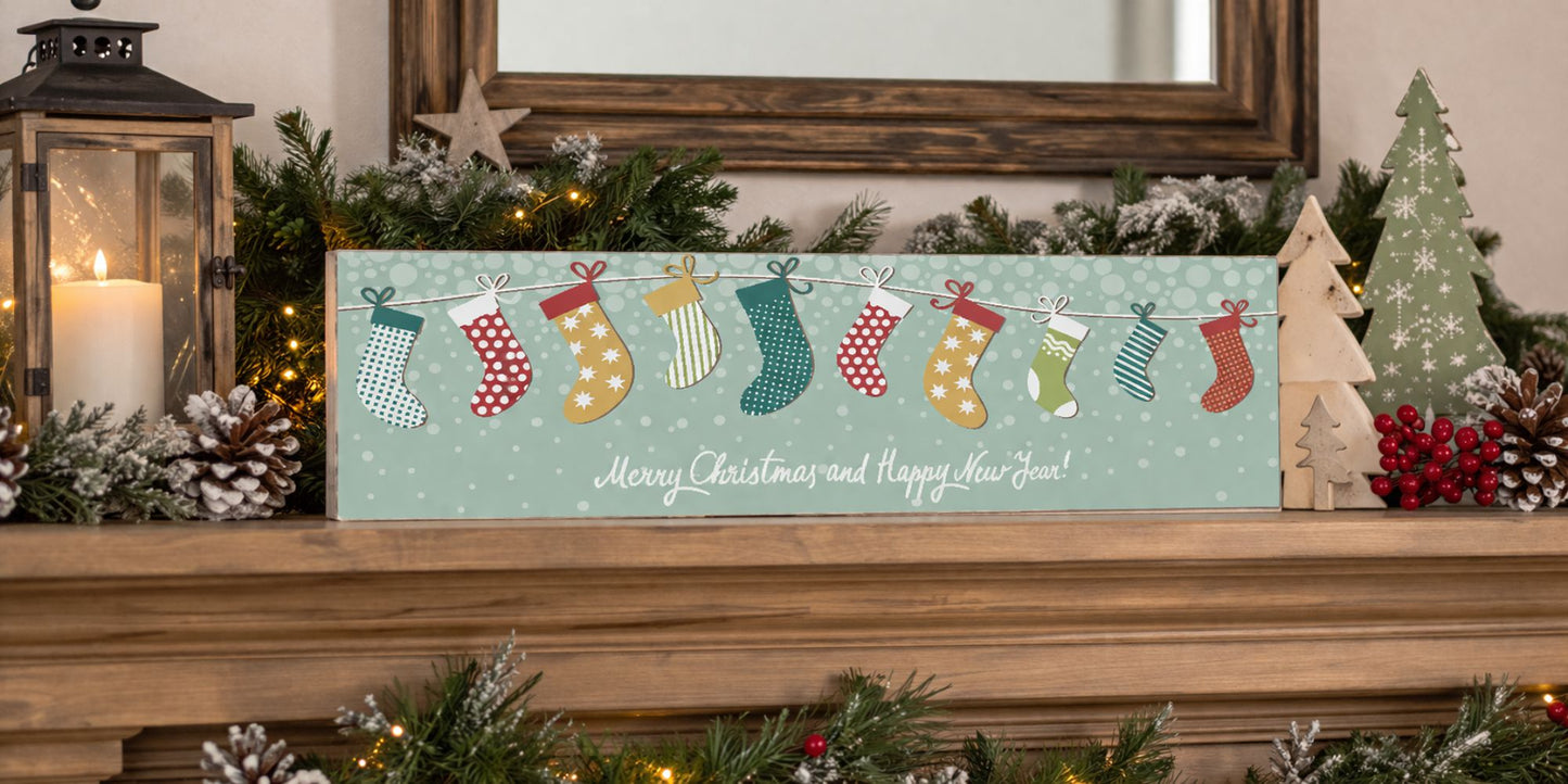 christmas stocking sign on mantel with greenery pinecones candle and holiday decor
