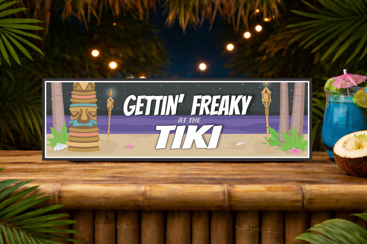 gettin freaky at the tiki tropical bar sign displayed on bamboo bar top with night tiki setting and soft lights
