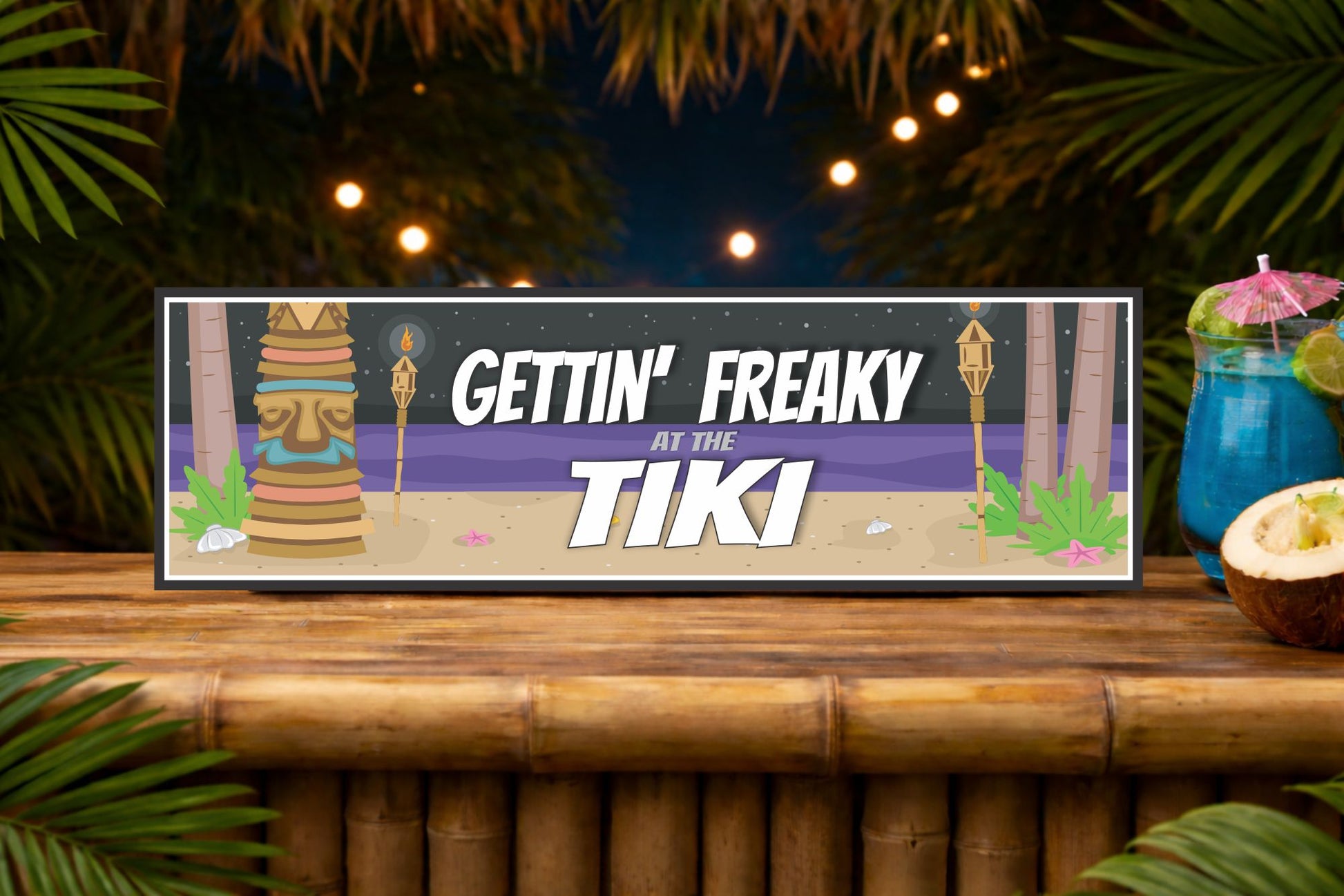 gettin freaky at the tiki tropical bar sign displayed on bamboo bar top with night tiki setting and soft lights