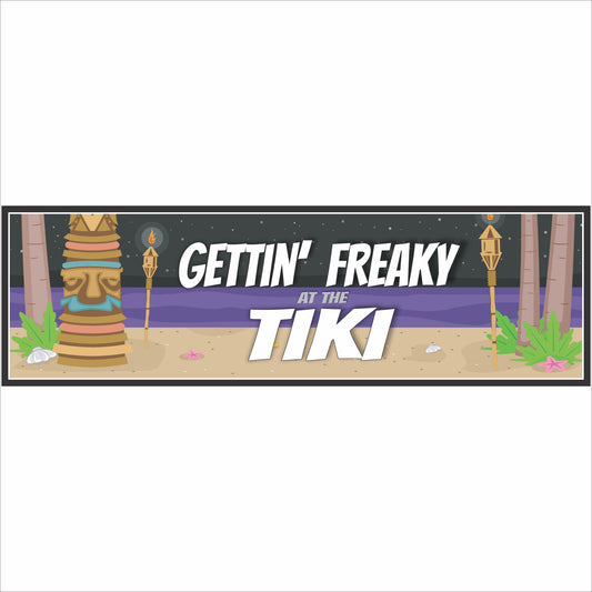 gettin freaky at the tiki sign close up tropical night beach design tiki mask torches bold white lettering
